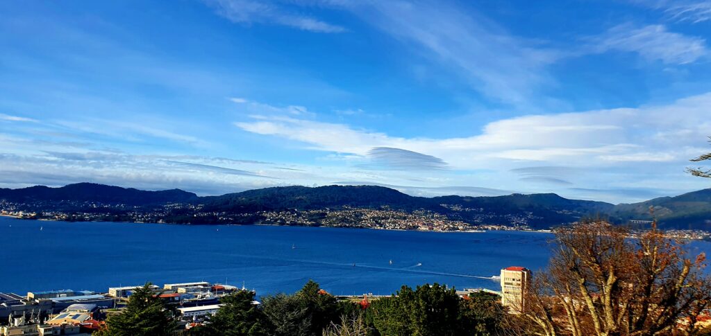 Scenic view of Vigo Bay with mountains and blue sky in the background.