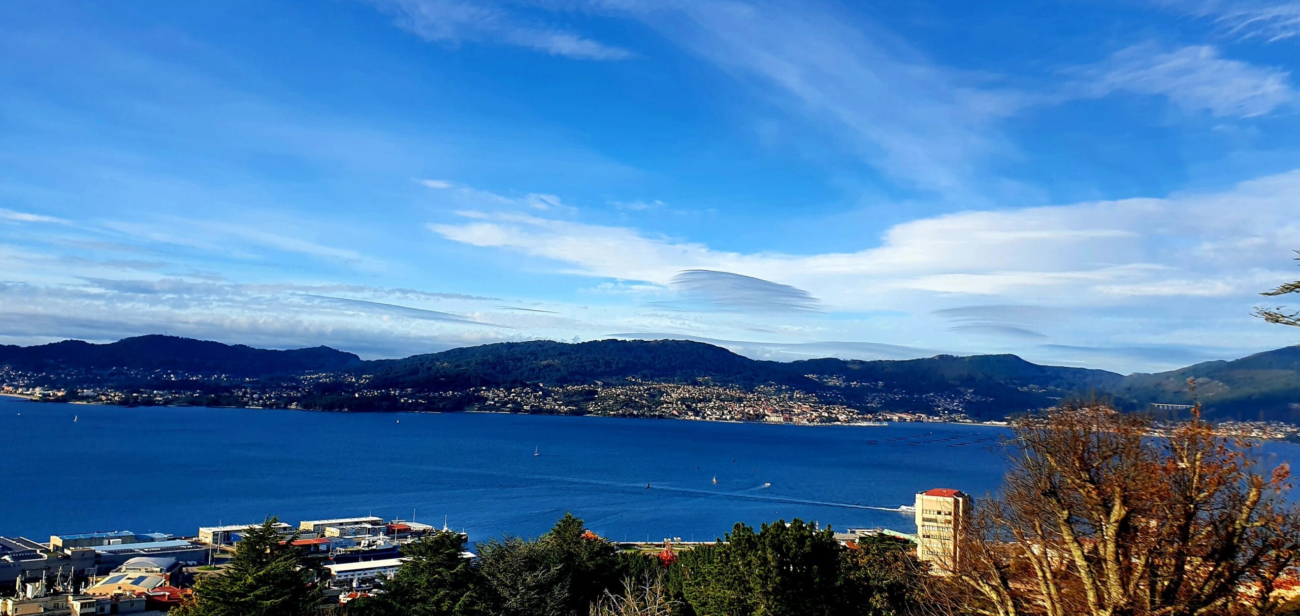 Scenic view of Vigo Bay with mountains and blue sky in the background.
