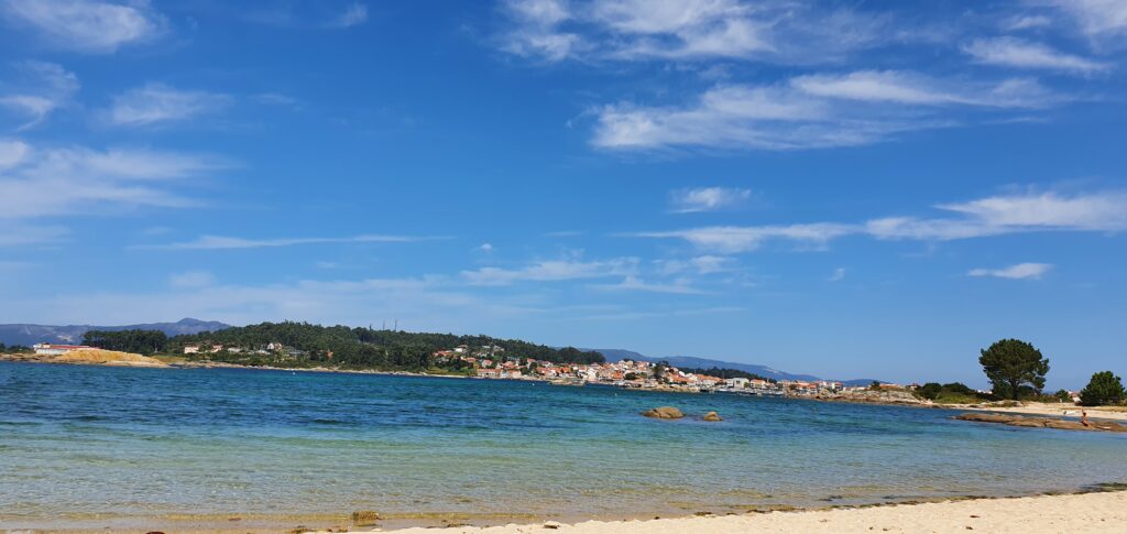 Beautiful coastal view of Galicia with blue sky and calm sea.
