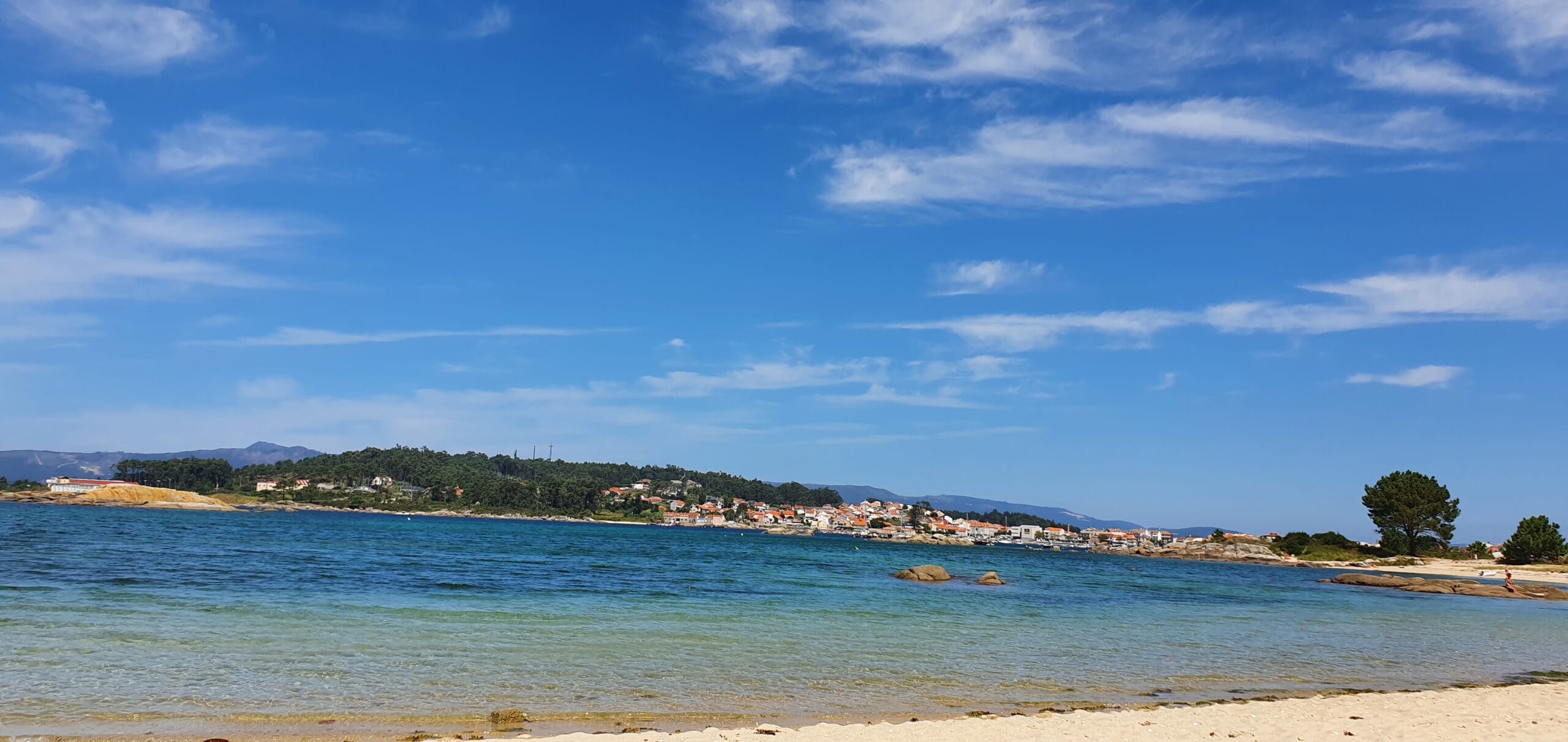 Beautiful coastal view of Galicia with blue sky and calm sea.